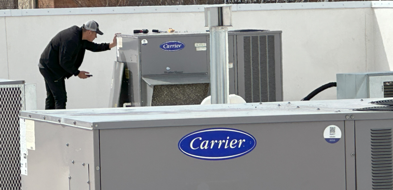 One of our expert technicians working on a commercial HVAC system